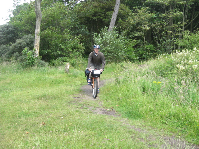Chris tackling the overgrown cycle path...